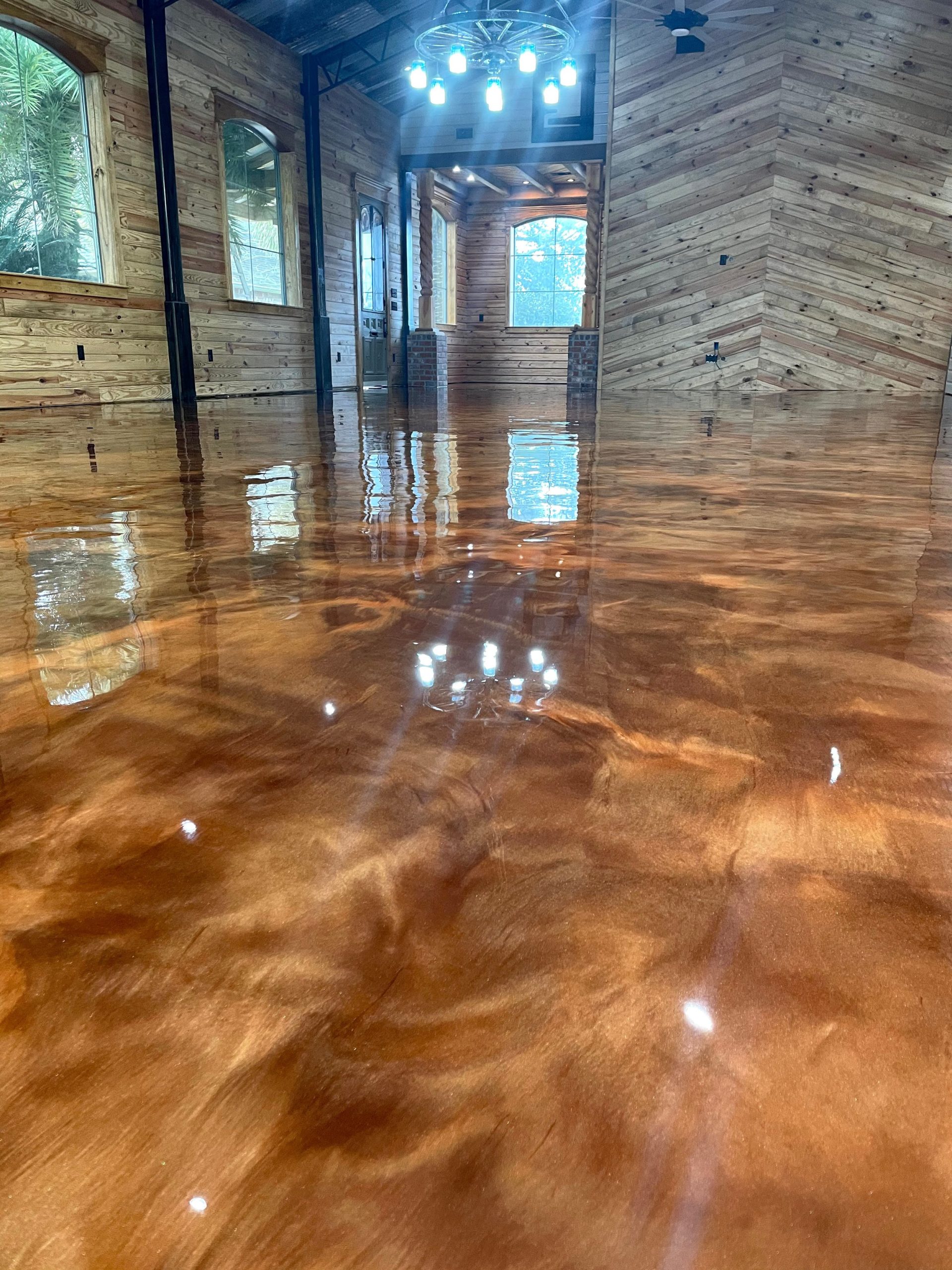 Red and gold metallic epoxy floor in a residential interior in San Antonio, TX