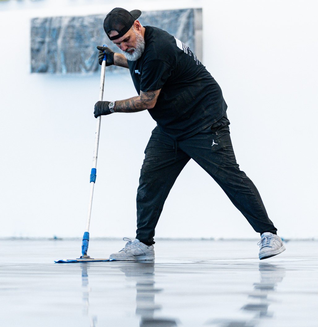 Kris Krislovik of Victory Epoxy squeegeeing a floor coat, confirmed guest at The Golden Pour Awards 2026